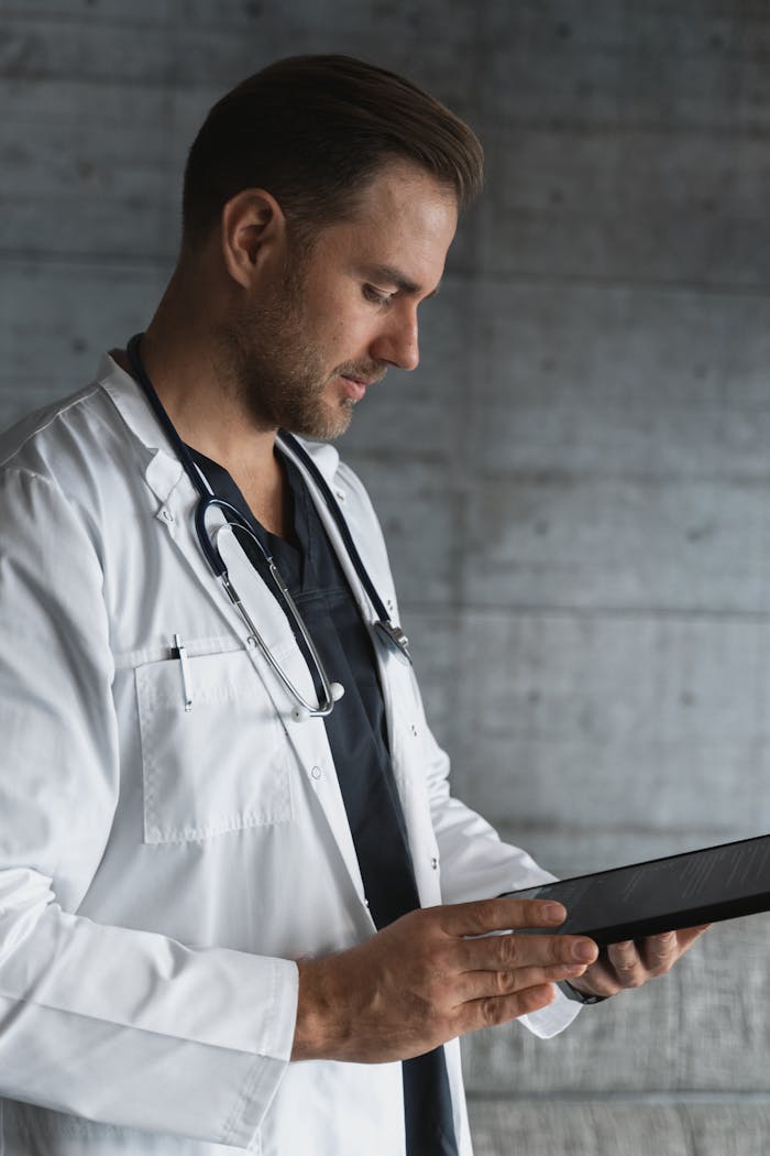 Crafting Captivating Headlines: Your awesome post title goes here Portrait of a confident male doctor using a tablet indoors.